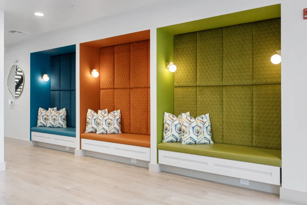 Recessed, upholstered seating nooks in a common area at The Aston at Uptown.